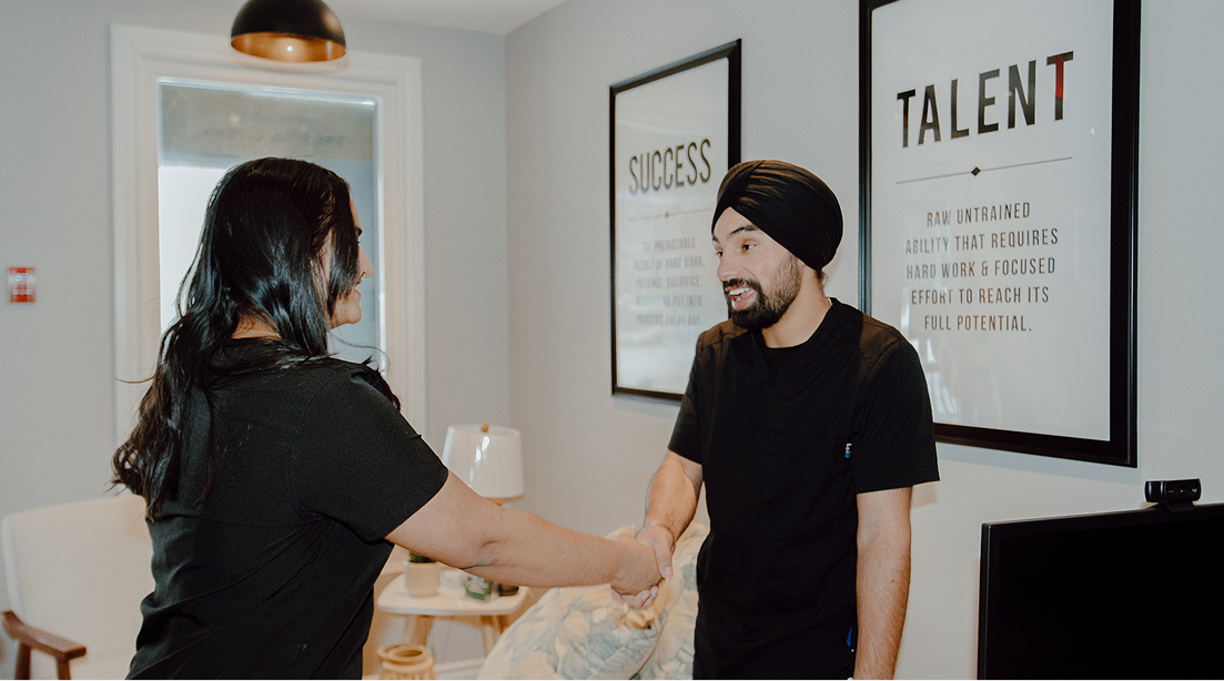 Two staffing coordinators shaking hands in an office